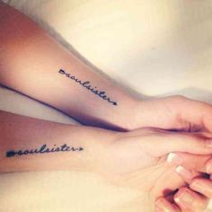 two people holding hands with tattoos on their arms and the words love is patient written in black ink