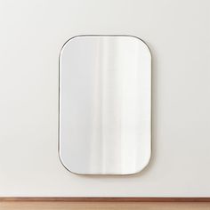 a square mirror mounted to the side of a wall