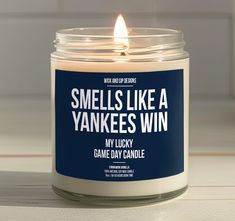 a candle that says smells like a yankees win on the front and side of it