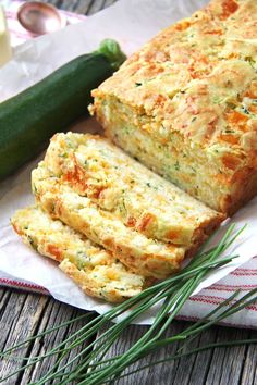 sliced zucchini bread on a napkin next to a cucumber