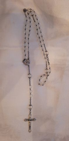 Beautiful vintage rosery made with crystals and sterling silver. The  spacer chain is not sterling.  The medal with Jesus on it is not marked. The cross is marked Italy. 21" long.  Great vintage condition. Due to the higher cost for shipping is that I take special care in packing to prevent breakage or damage and the size of box. Please look at all pictures and ask questions before purchasing. I do not accept returns and all sales are final. I ship all packages USPS from Pinehurst, Texas 77362. Vintage Silver Beaded Crystal Necklace, Spiritual Silver Single Strand Crystal Necklace, Vintage Silver Beaded Crystal Necklaces, Vintage Silver Beaded Necklaces In Crystal, Silver Beaded Chain Rosary, Elegant Adjustable Rosary With Silver Beads, Elegant Adjustable Silver Beads Rosary, Silver Spiritual Crystal Necklace With Beaded Chain, Spiritual Silver Crystal Necklace With Beaded Chain