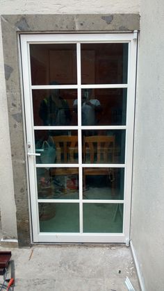 an open glass door on the side of a building