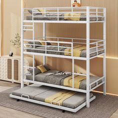 a white bunk bed sitting on top of a wooden floor