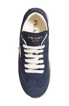 Goatskin suede elevates this monochromatic low-top sneaker that features three versions of the iconic Prada logo. Lace-up style Removable insole Leather upper and lining/synthetic sole Made in Italy Designer Shoes Sporty Low-top Sneakers With Logo Plaque, Luxury Navy Sneakers With Contrast Sole, Luxury Suede Sneakers For Streetwear, Luxury Navy Sneakers With Textured Sole, Luxury Low-top Platform Sneakers With Logo, Luxury Low-top Sneakers With Logo Detail, Cute Sneakers For Women, Luxury Navy Low-top Sneakers, Prada Triangle