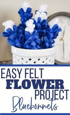 blue flowers in a white vase with text overlay that reads easy felt flower project blueberries