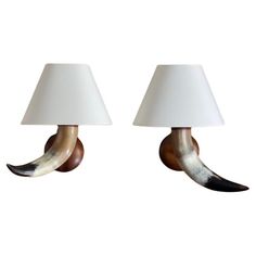 two lamps with horns on them sitting next to each other