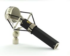 an old fashioned microphone on a tripod with a mic attached to the top one