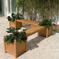 a wooden bench with two planters on it