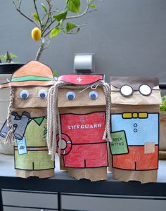 three paper bag puppets are sitting on a table