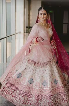 a woman in a pink and white bridal gown