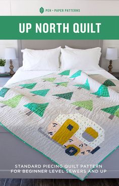 a bed with a quilt on top of it next to pillows and pillowcases