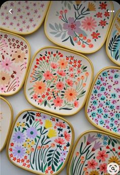 many colorful plates with flowers painted on them