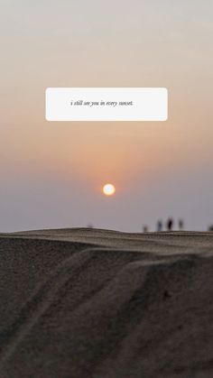 the sun is setting over some sand dunes and people are walking on top of it