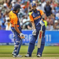 two men standing next to each other on a field