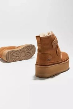 Reimagining UGG’s timeless chukka for a bolder look than ever before, this Neumel reaches new heights with a leg-lengthening platform and easy hook-and-loop straps. Crafted in rich suede, it's lined in the iconic sheepskin with an UGGplush™ insole for signature softness. Content + Care: - Suede, UGGplush™ (80% upcycled wool, 20% lyocell), rubber - Spot clean - Imported Size + Fit: - True to size - Platform height: 2'.UGG creates ultra-cozy boots, slippers, sandals and more in their iconic fluff-forward designs. The original favorites feature sheepskin and suede while sustainable sandal styles utilize renewable materials to create their signature fluffy finish. Ugg Shoes Women, Ugg Neumel, Platform Boots Women, Boots Slippers, Cozy Boots, Uggs Outfit, Boot Straps, Classic Mini, Sandal Fashion