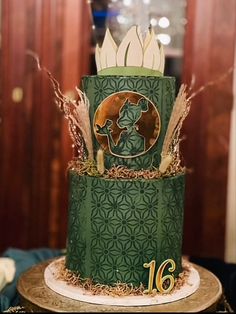 a green and white cake with gold decorations