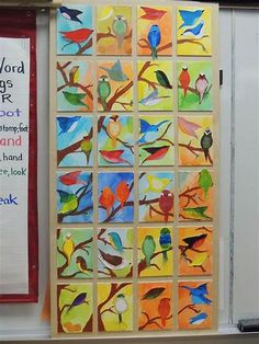 an art project is displayed on the wall in front of a bulletin board with colorful birds