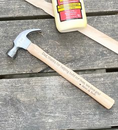 a hammer and some other tools sitting on a bench next to a bottle of glue