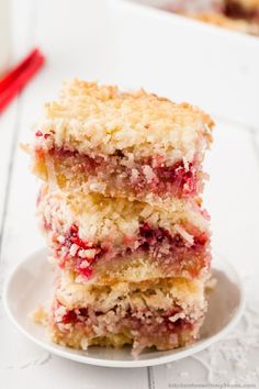 three pieces of cake sitting on top of a white plate next to a red fork