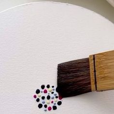 a paintbrush with some black and white dots on it