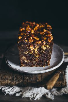 a piece of cake sitting on top of a white plate next to a wooden table