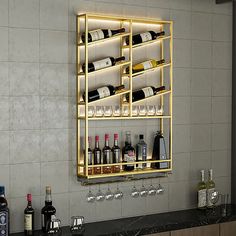 a wall mounted wine rack filled with lots of bottles and glasses on top of a counter