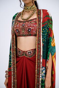 This stunning set features a red Mughal cape paired with an intricately embroidered bralette and a matching skirt. Perfect for festive occasions or special events, this ensemble brings together traditional elegance with a contemporary twist. Mughal Motifs, Skirt Cape, Tassel Jacket, Cape Set, Traditional Aesthetic, Regal Elegance, Lehenga Suit, Long Cape, Indian Wedding Wear