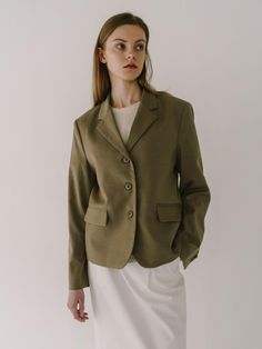 This jacket showcases a blazer with a notched lapel, contributing to a refined and professional silhouette. It is styled with a two-button front closure which is standard for a classic blazer design. The tailored garment includes patch pockets, adding a touch of casual functionality. Its fabric appears smooth and likely has a fine weave, indicating a quality construction.- The blazer features a structured shoulder, enhancing the garment's tailored form.- The sleeves terminate at the wrist, with no visible buttons or embellishments on the cuffs.- This piece, with its timeless design, could be versatile in both formal and semi-formal settings. Classic Button-up Blazer For Work, Timeless Single Breasted Blazer For Spring, Timeless Single-breasted Blazer For Spring, Timeless Single-breasted Spring Blazer, Tailored Button-up Blazer For Career, Classic Notched Blazer For Spring, Classic Single-breasted Spring Blazer, Classic Single Breasted Blazer For Spring, Classic Spring Single-breasted Blazer