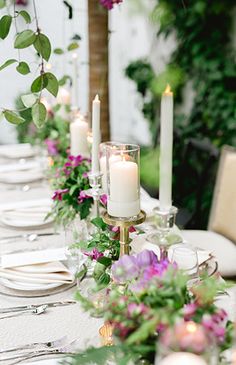 a long table is set with candles and flowers for an elegant dinner party or wedding reception