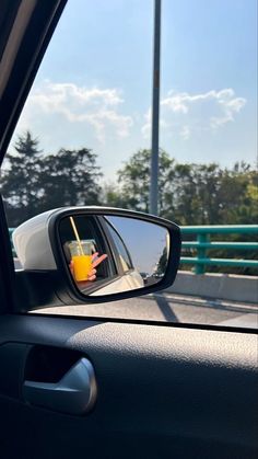 a side view mirror with a drink in it