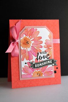 an orange card with pink flowers on it and a ribbon tied around the edge that says, with love sunshine