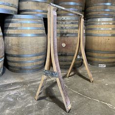 an old wooden stand in front of some barrels