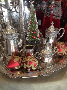 an ornate silver tray with christmas decorations on it