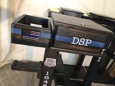 three wooden boxes with the word dsp on them and an american flag sticker