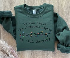 "Christmas Taylor Sweatshirt Taylor Holiday Sweater Swifti Christmas Gift Christmas Lights Christmas Tree TS shirt Eras Tour Shirt Concert Get ready for the holiday season with this \"We can leave the Christmas lights up til January\" Christmas sweatshirt! This trendy Christmas shirt is perfect for any music fan who's excited about Christmas, loves Taylor, and is in their jolly era! The design features a bold and festive font that's sure to catch everyone's eye. Whether you're wearing it to a Ch Taylor Swift Christmas Shirt, Taylor Swift Christmas Sweatshirt, Cute Christmas Sweaters, Sweater Song, Taylor Swift Christmas, Best Friend Christmas Gifts, Sweet Tee, Christmas Concert, Concert Shirts