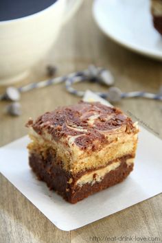 a close up of a piece of cake on a plate with chocolate chips around it