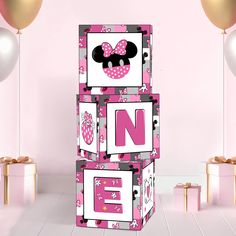 a pink and white box with minnie mouse on it's side, in front of balloons