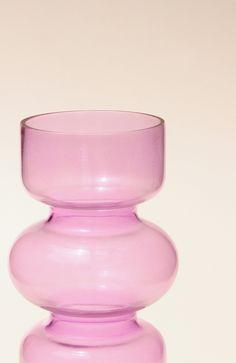 a pink vase sitting on top of a table