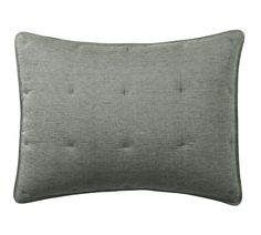 a gray pillow with buttons on the front and back side, against a white background