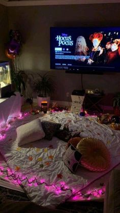 a living room filled with furniture and a flat screen tv mounted to the side of a wall