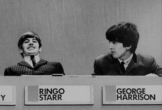 three people sitting at a table with signs in front of them that say ringo star and george harrison