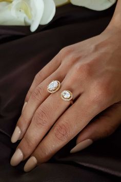 a woman's hand with two rings on it