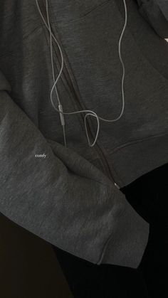 the hoodie has ear buds attached to it