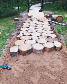 several logs are stacked on top of each other in the middle of a yard area