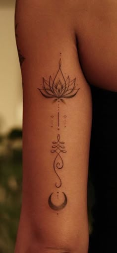 a woman's arm with a lotus tattoo on the left side of her body