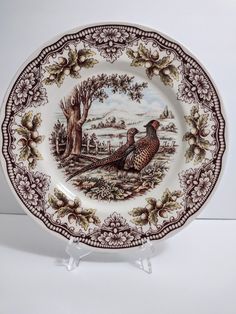 a plate with two pheasants on it