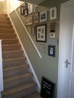 a staircase with pictures on the wall and framed photos on the wall next to it