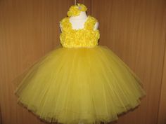 This gorgeous tutu dress is lovingly handmade with close attention to details. 240 yards of soft yellow tulle in this dress make it very full. Pearls are placed in the center of each flower. The shoulder straps are adjustable, ties in the back for a pretty bow! Please select the size according to length (Length measured from armpit to ankle). The crochet top is stretchy and will fit well. Length measured from armpit to ankle *  SIZES: us 0-3 months:dress length-14'' us 3-6  months:dress length-1 Yellow Tulle Tutu Dress For Spring, Yellow Tulle Skirt Tutu Dress For Party, Yellow Tutu Dress With Tulle Skirt For Spring, Spring Yellow Tulle Tutu Dress, Spring Yellow Tutu Dress With Tulle Skirt, Yellow Wedding Tutu Dress With Ruffles, Yellow Princess Dress For Birthday In Spring, Fitted Yellow Tutu Dress With Tulle Skirt, Yellow Ruffled Tutu Dress For Wedding