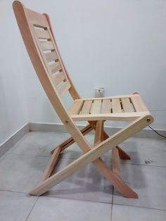 a wooden chair sitting on top of a tile floor