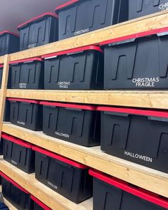 the shelves are filled with black plastic bins